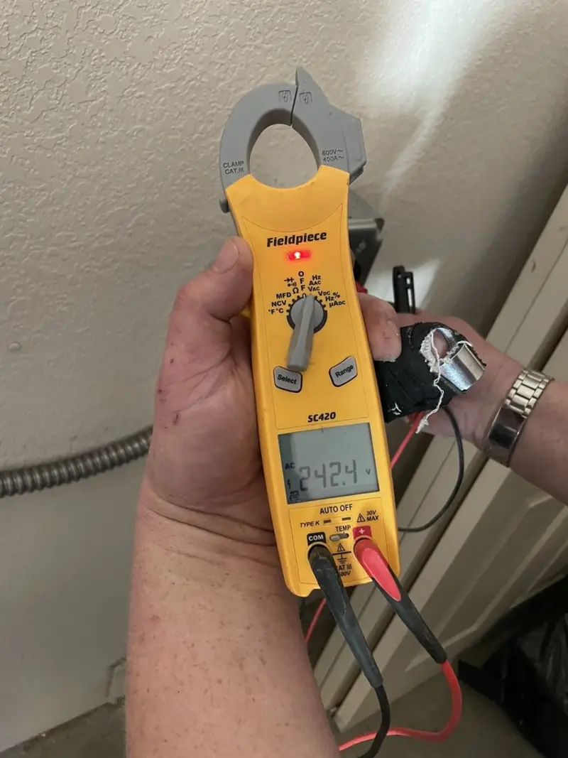 Voltage testing with clamp meter during Ceiling Fan Installation in Champlain